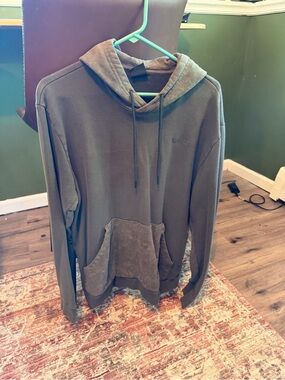 Oakley Men's Olive Green Pullover Hoodie with distressed hood and front pocket.